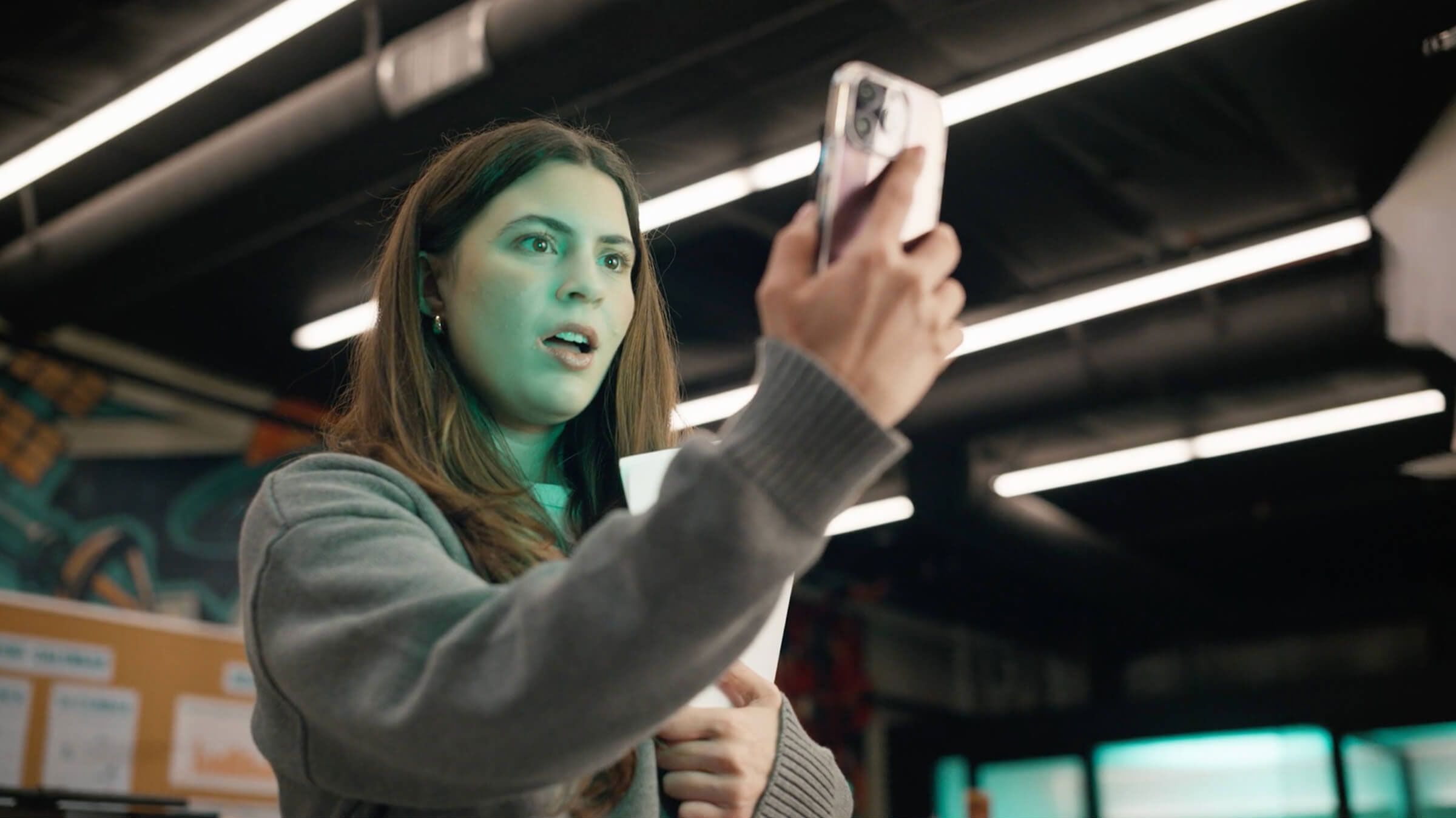 Woman looking at phone in warehouse